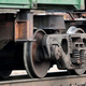 A photo of train wheels on a Norfolk Southern carriage.